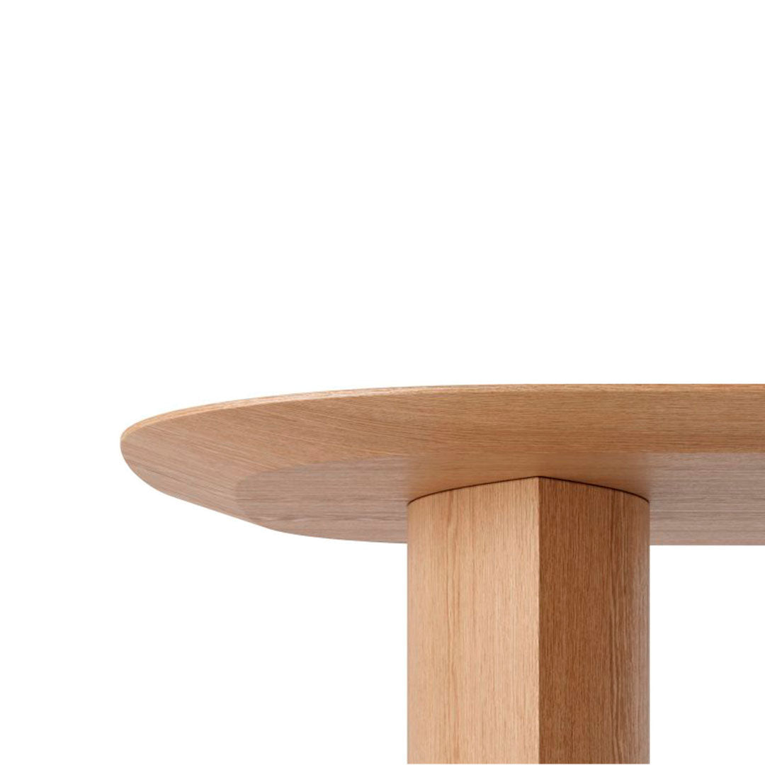 Light wood tabletop with a smooth, rounded edge and a solid rectangular leg, showcasing natural wood grain.