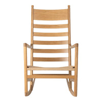 Natural wood rocking chair with elegant slatted design, showcasing smooth beige tones and minimalist style.