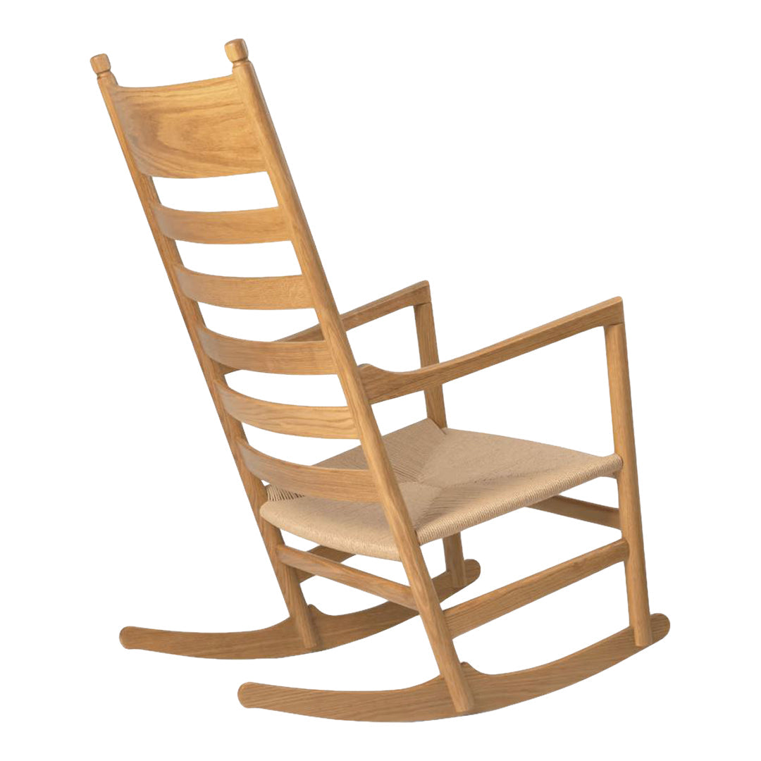 Light oak rocking chair with a natural wood finish and a simple, minimalist design. Neutral fabric seat.