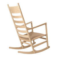 Lightly finished natural wood rocking chair with a classic slatted back and simple, streamlined design.