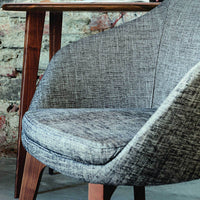 Gray textured upholstery with a smooth finish and wooden legs, perfect for modern decor.