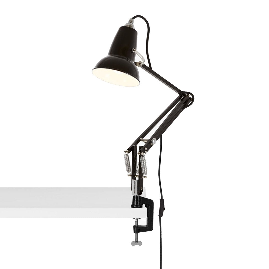 Black articulated desk lamp with a sleek, modern design and a smooth white clamp, perfect for any workspace.