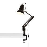 Black articulated desk lamp with a sleek, modern design and a smooth white clamp, perfect for any workspace.