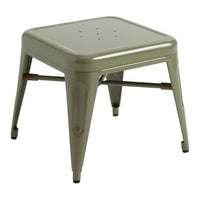 Green metal stool with a smooth, shiny finish and perforated seat design, perfect for modern decor.