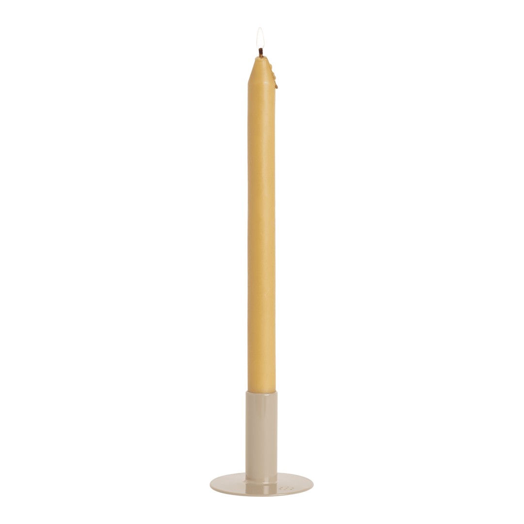 Tall yellow candle with a smooth finish, set in a minimalist beige holder. Ideal for elegant decor.