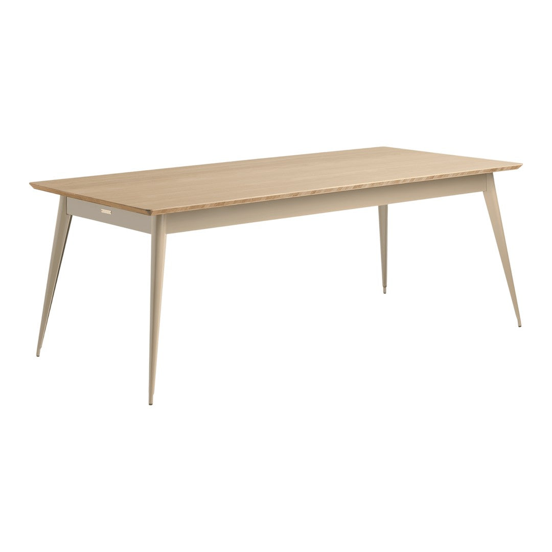Light wood dining table with a smooth finish and tapered legs, showcasing a minimalistic, modern design.