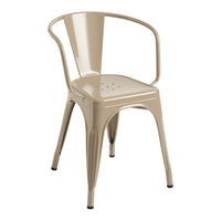 Beige metal chair with a sleek, modern design and a perforated seat pattern, perfect for various decor styles.
