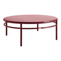 Round red coffee table with a sleek, modern design and minimalist structure. Ideal for contemporary spaces.
