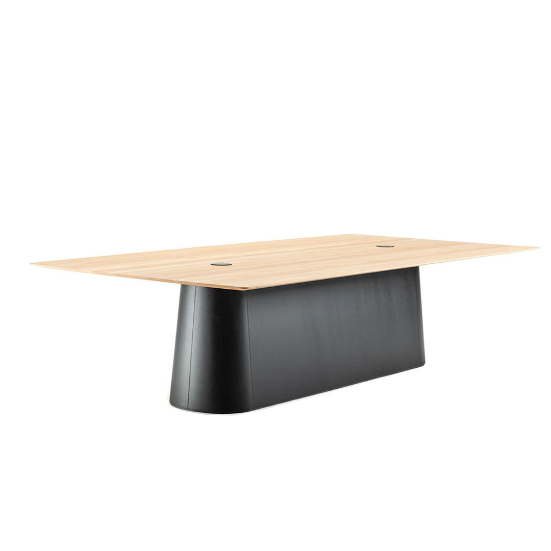 Modern rectangular table with a light wooden top and a sleek black base, featuring minimalistic design and clean lines.