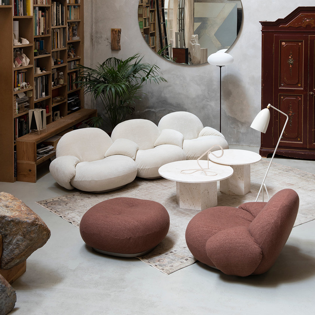 Stylish cream and terracotta furniture with unique, rounded designs in a modern living space.