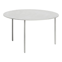 Round white table with a smooth surface and sleek silver legs, perfect for minimalist decor.