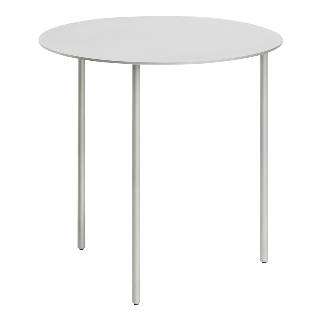 Minimalist round table with a sleek white top and slender silver legs, perfect for modern decor.
