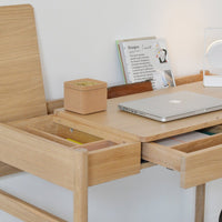 Light wood desk with a smooth finish, featuring natural grain patterns and a minimalist design.