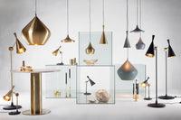 Elegant gold and gray lamps with sleek designs, set against a minimalist white background. Perfect for modern decor.