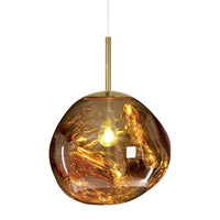 Amber-hued pendant light with a unique, marbled pattern and a sleek, gold fixture. Perfect for modern decor.