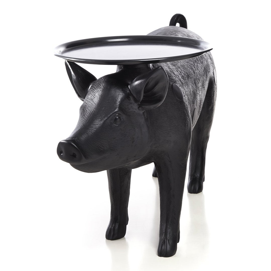 Black pig-shaped table with a glossy black tray, featuring a textured finish and playful design.