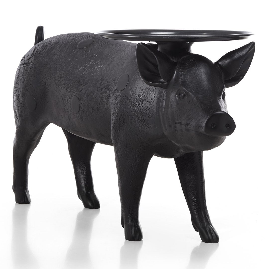 Black ceramic pig-shaped stool with glossy finish, featuring a round tray on its back. Perfect for rustic decor.