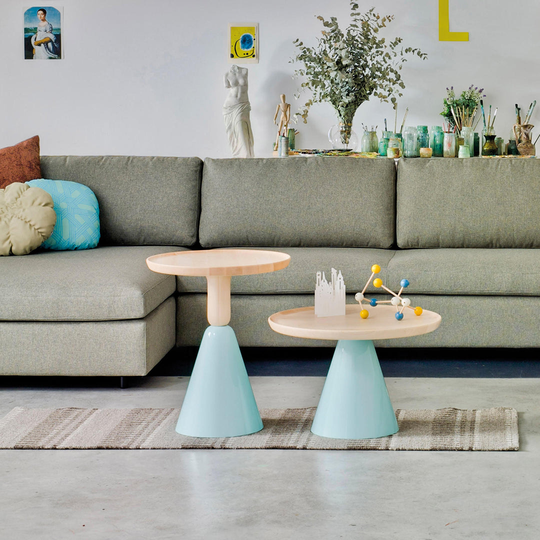 Modern accent tables with light wood tops and mint green bases, featuring a simple, contemporary design.