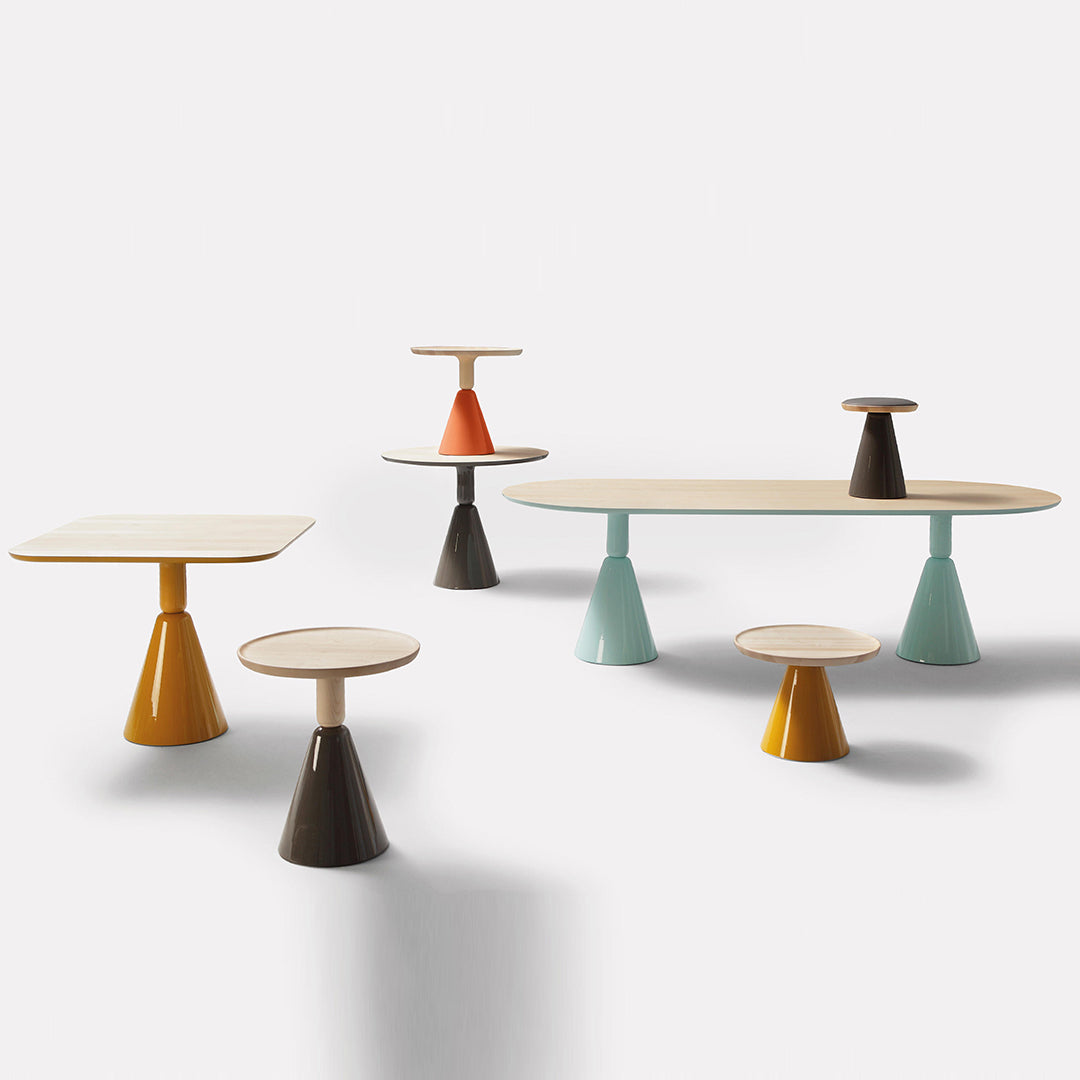 Colorful modern tables in orange, teal, yellow, and brown with smooth surfaces and unique geometric shapes.