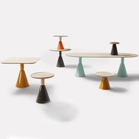 Colorful modern tables in yellow, orange, turquoise, and brown with unique geometric patterns.