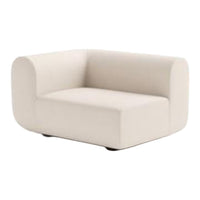 Creamy white curved armchair with a minimalist design and smooth fabric finish; perfect for modern décor.