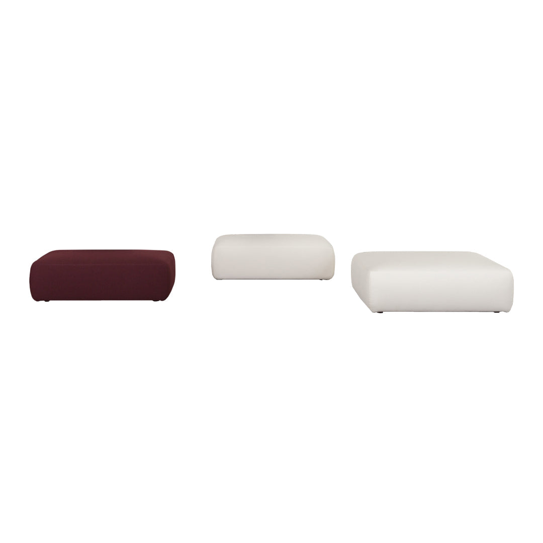 Set of three poufs in deep burgundy and soft white, featuring smooth, contemporary designs with rounded edges.