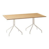 Light brown wooden table with a slatted design and white metal tripod legs, ideal for modern outdoor settings.