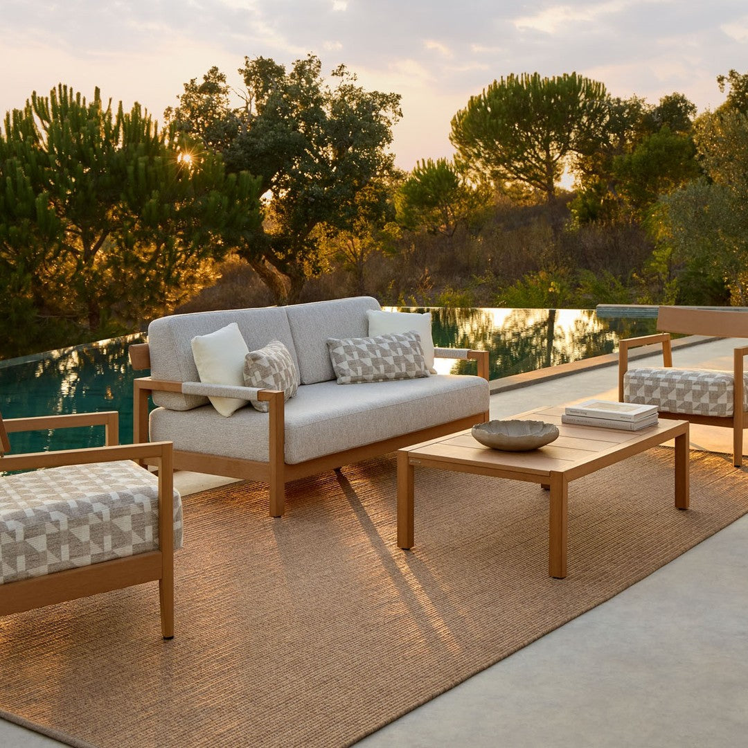 Modern outdoor seating set featuring neutral tones and geometric patterned cushions, perfect for stylish patio decor.