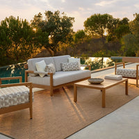 Modern outdoor seating set featuring neutral tones and geometric patterned cushions, perfect for stylish patio decor.