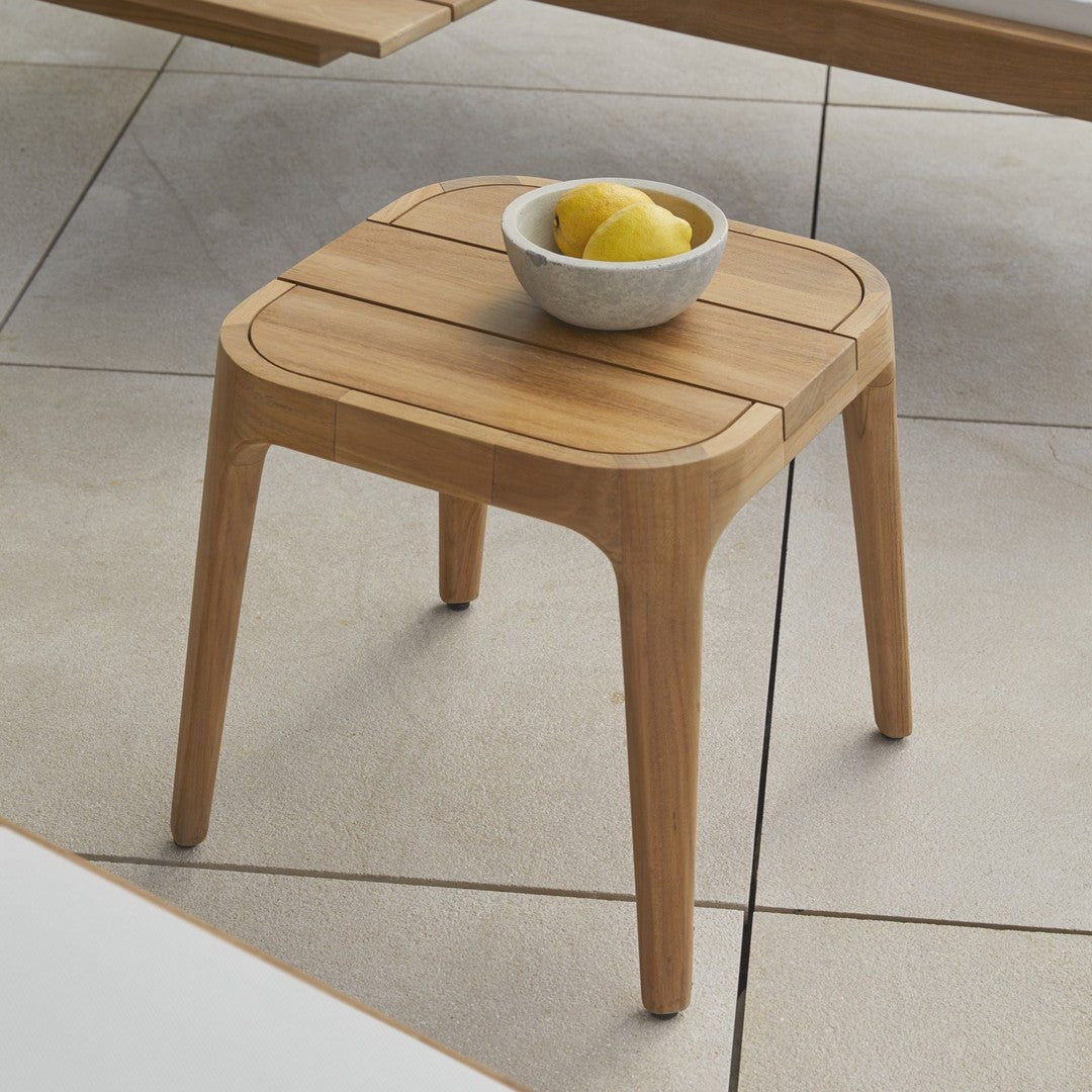 Natural wood square side table with subtle grain pattern, featuring a light beige ceramic bowl and vibrant yellow lemons.