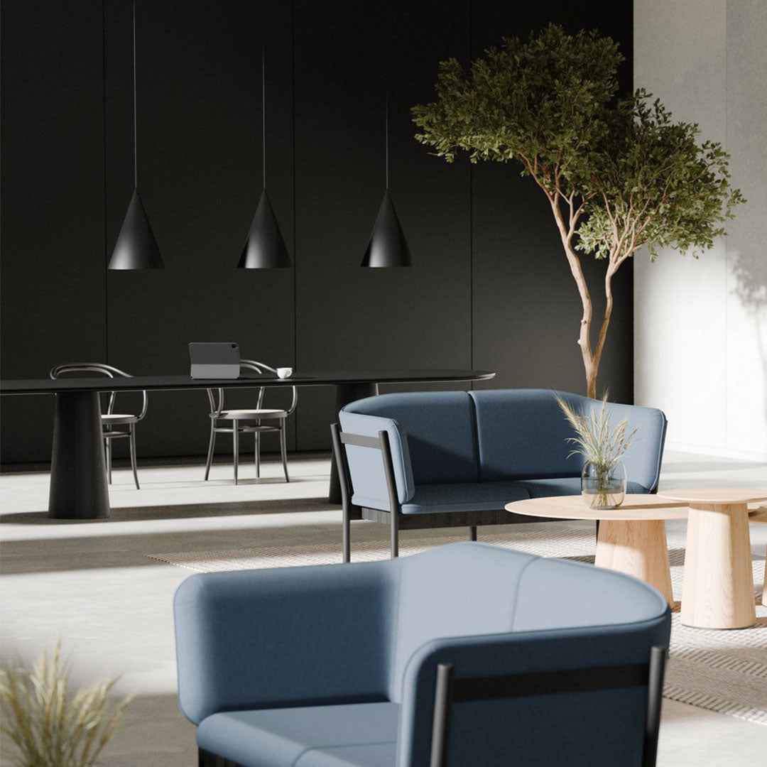 Blue upholstered chairs with sleek lines, black accents, and a minimalist design, set against a neutral backdrop.