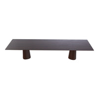 Dark wood coffee table with a smooth, rectangular top and uniquely shaped light wood legs.