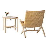 Woven natural rattan chair with a light wooden frame, paired with a minimalist round table. Soft beige tones.