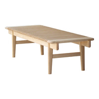 Light wood coffee table with slatted design and natural finish, showcasing a simple and modern aesthetic.