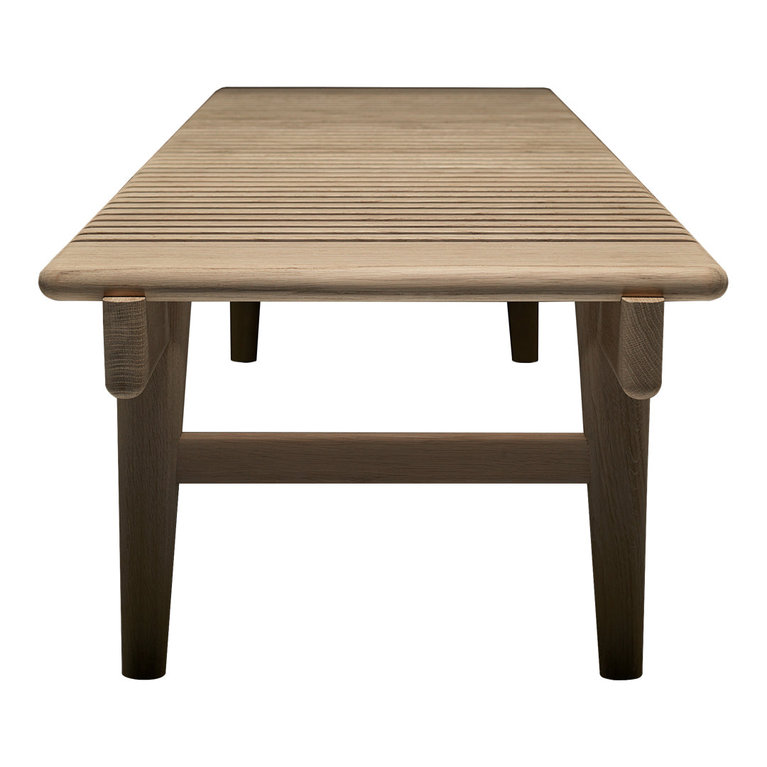 Wooden coffee table with a sleek, natural finish and subtle grain pattern, featuring sturdy, tapered legs.