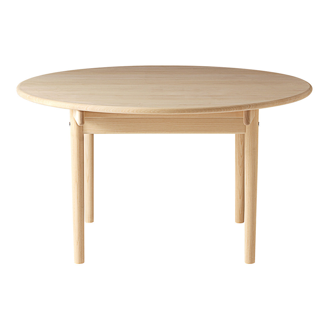 Round wooden table with a natural light beige finish and smooth surface, featuring simple, clean lines.