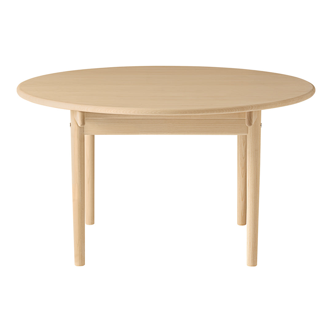 Light beige round table with smooth finish and simple design. Perfect for modern dining spaces.