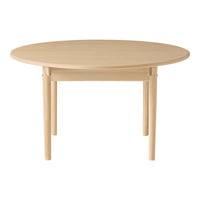 Light beige round table with smooth finish and simple design. Perfect for modern dining spaces.