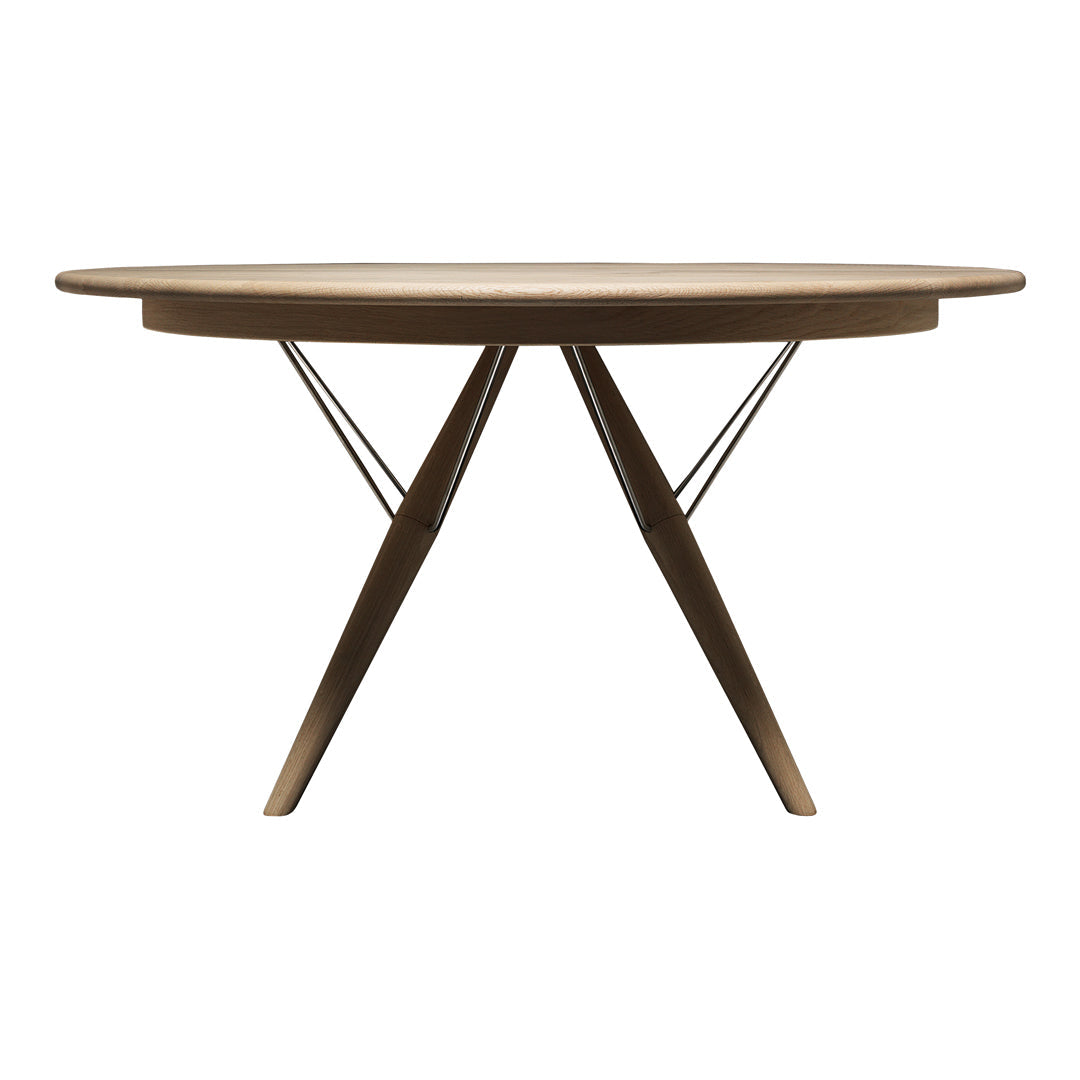 Modern round wooden dining table with a natural brown finish and sleek black metal legs, showcasing a minimalist design.