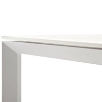 White table corner with a sleek, minimalistic design highlighting smooth surfaces and straight lines.