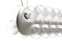 Clear glass globes with smooth white fixture, creating a modern, minimalist design aesthetic.