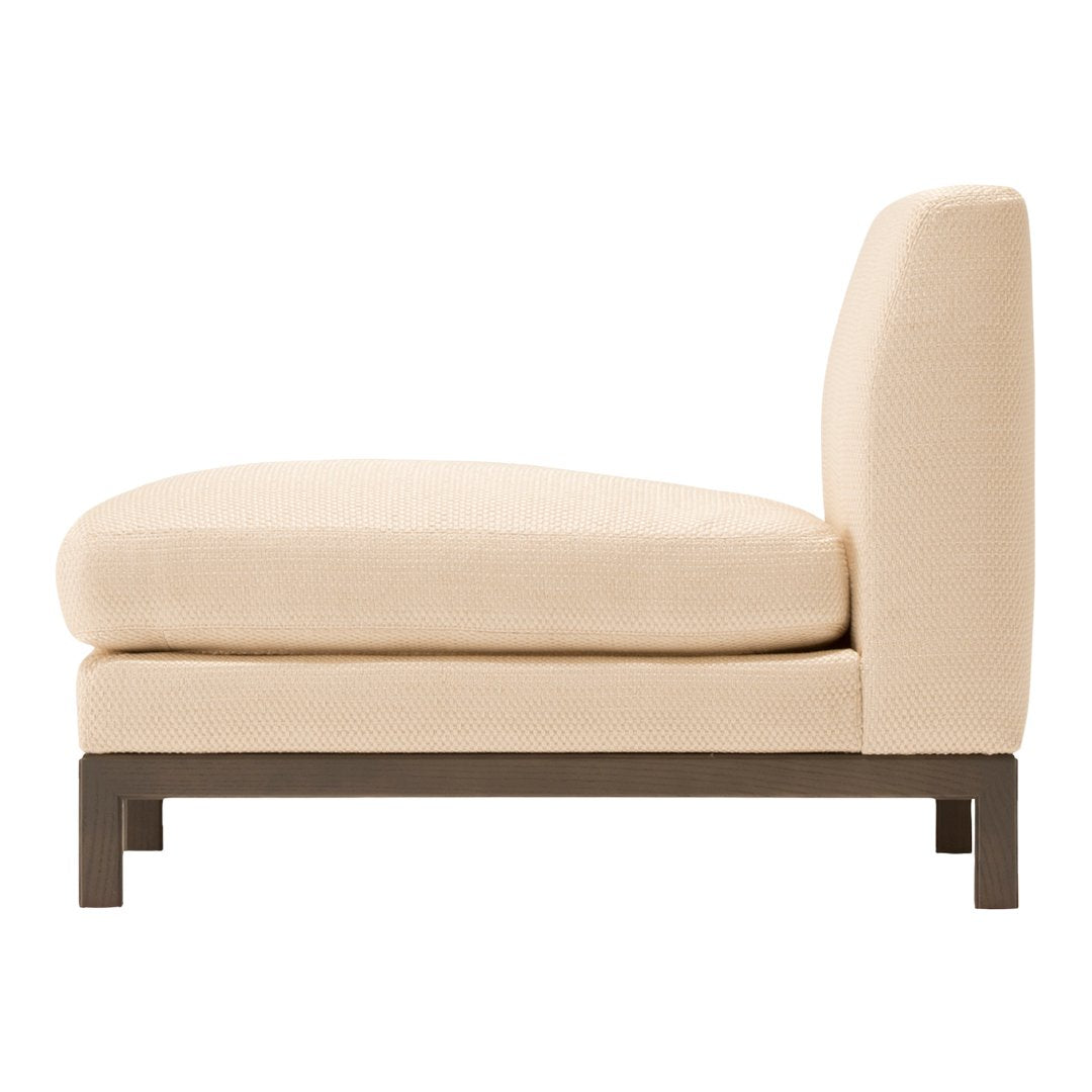 Cream-colored upholstered lounge chair with a minimalist design and a dark wood frame.