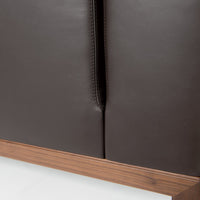 Dark brown leather upholstery with a smooth finish, paired with a natural wood base. Minimalist design details.
