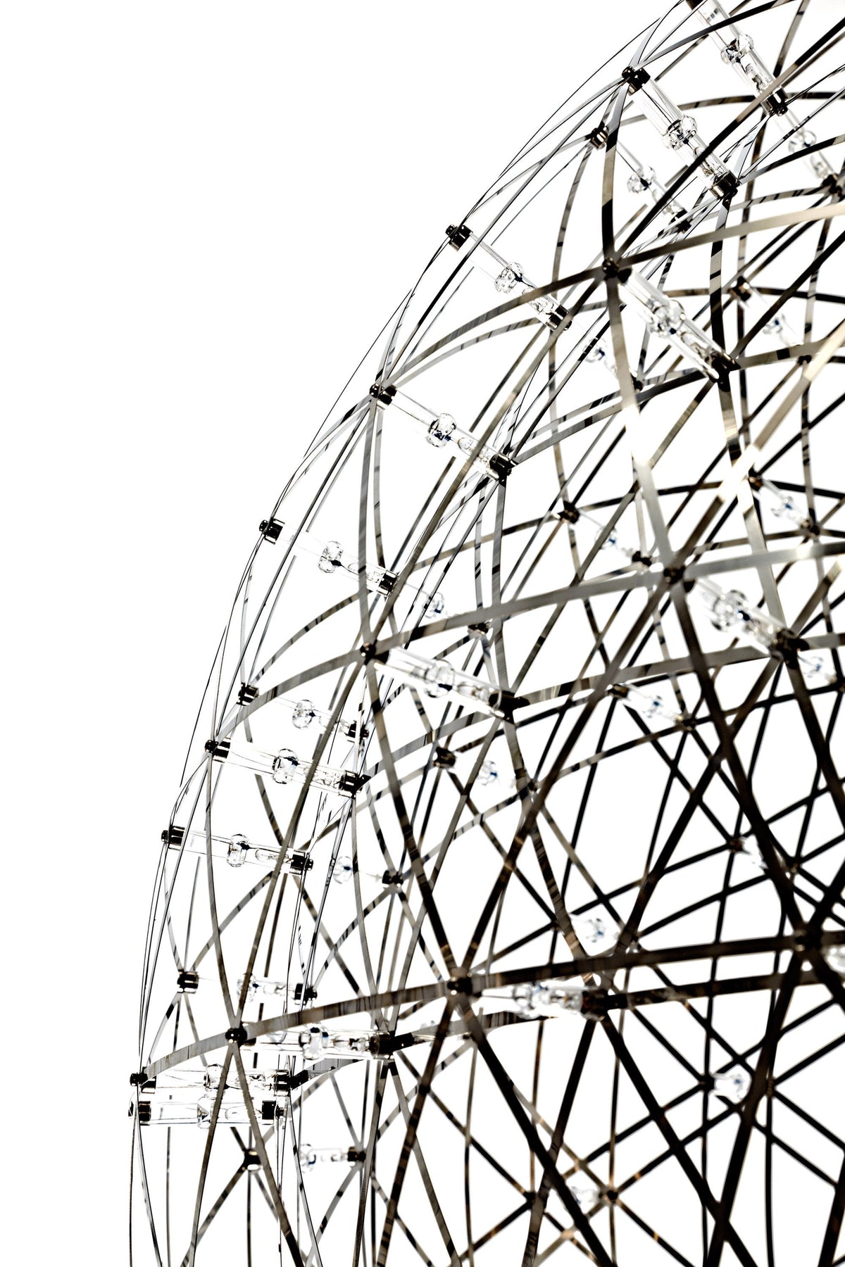 Geometric black and white wireframe globe with intricate patterns and bright accent lights. Modern design element.