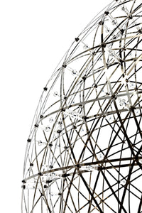 Geometric black and white wireframe globe with intricate patterns and bright accent lights. Modern design element.