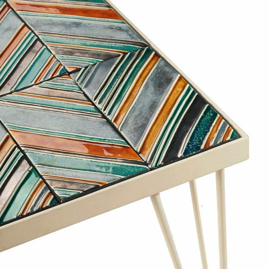 Colorful geometric mosaic tabletop featuring teal, orange, silver, and black patterns with a modern design.