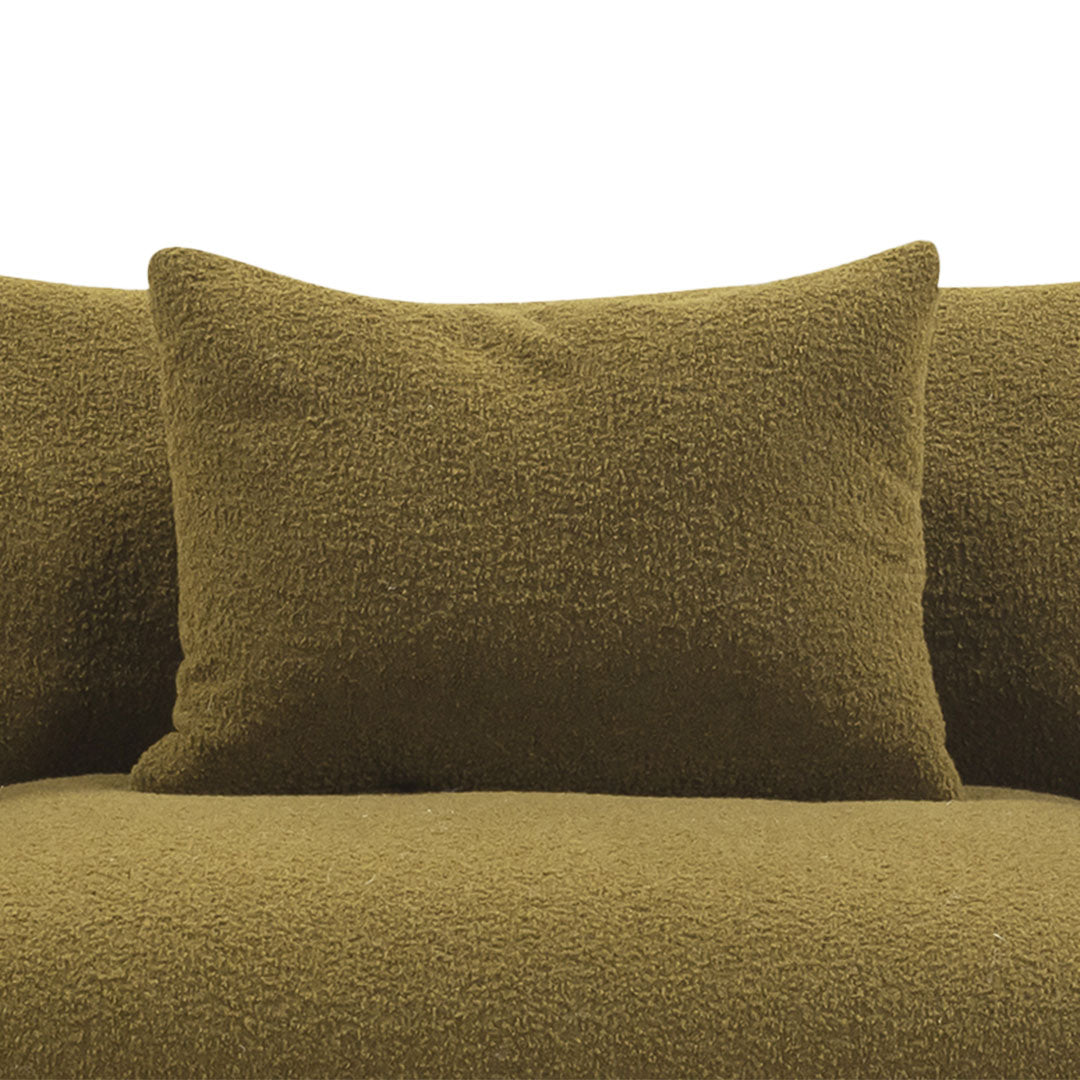 Textured olive green pillows on a plush olive green couch, enhancing modern decor with a cohesive color scheme.