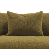 Textured olive green pillows on a plush olive green couch, enhancing modern decor with a cohesive color scheme.