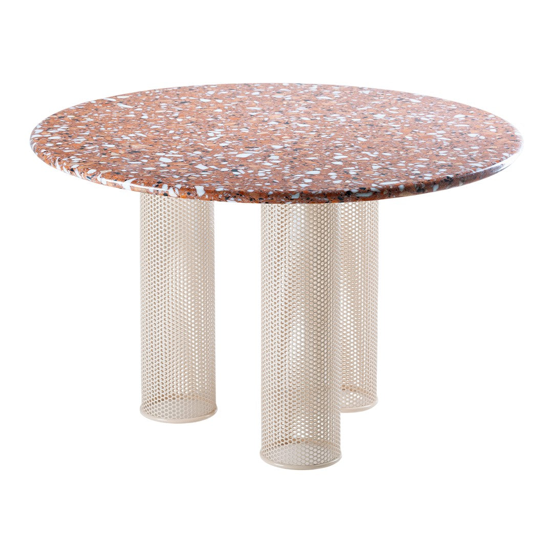 Round table with a speckled orange and white patterned top, featuring beige mesh legs for a modern aesthetic.