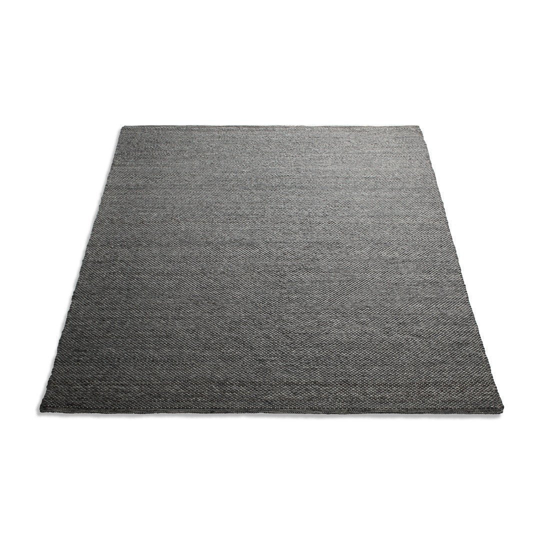 Textured dark gray area rug with a subtle, woven pattern, perfect for modern decor.